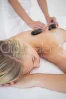 Beautiful blonde enjoying a hot stone massage