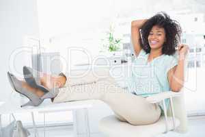 Happy businesswoman sitting with her feet up