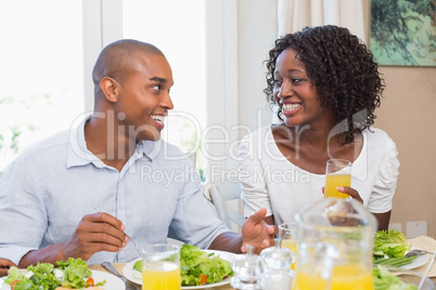 Couple enjoying a healthy meal together smiling at each other