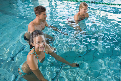 Fitness class doing aqua aerobics on exercise bikes