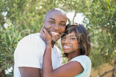 Happy couple hugging each other in garden