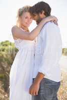 Attractive couple embracing by the road