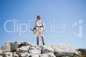 Handsome hiker standing at the summit looking around