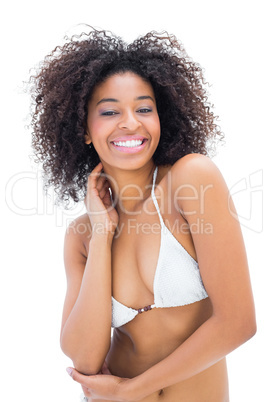 Fit girl in white bikini smiling at camera