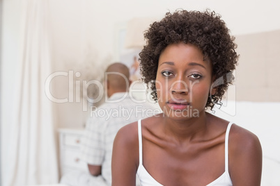 Unhappy couple not speaking to each other on bed