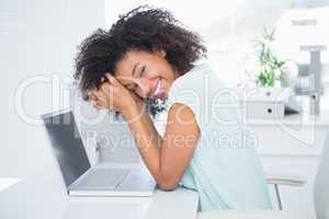 Happy businesswoman taking a break at desk