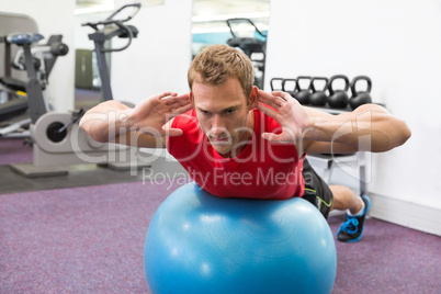 Fit man working his core on exercise ball