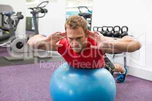 Fit man working his core on exercise ball