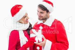 Attractive festive couple holding a gift