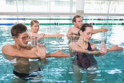 Happy fitness class doing aqua aerobics