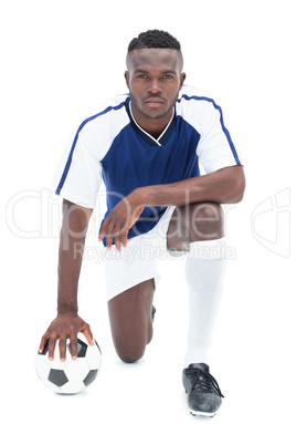 Serious football player in blue jersey