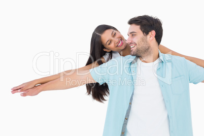 Happy casual man giving pretty girlfriend piggy back