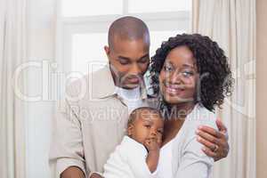 Happy young parents spending time with baby