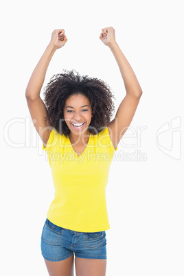 Pretty girl in yellow tshirt cheering at camera