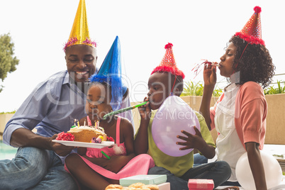 Happy family celebrating a birthday together in the garden