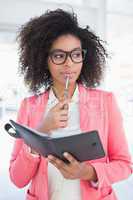 Casual businesswoman looking in her diary