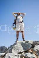 Handsome hiker standing at the summit