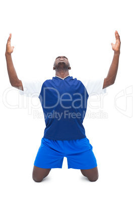 Football player in blue celebrating a win