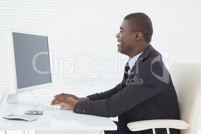 Cheerful businessman working at his desk