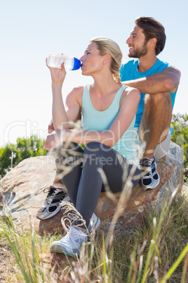 Fit couple taking a break at summit looking at the view