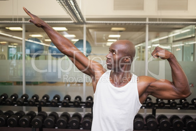 Muscular man posing in gym