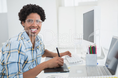 Young designer working at his desk with digitizer