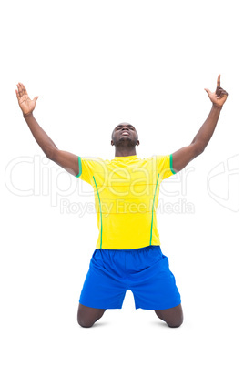 Football player in yellow celebrating a win