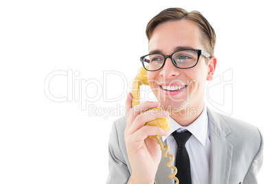 Geeky businessman talking on retro phone