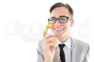 Geeky businessman talking on retro phone