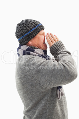 Sick mature man blowing his nose