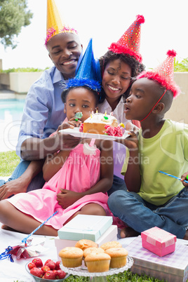 Happy family celebrating a birthday together in the garden