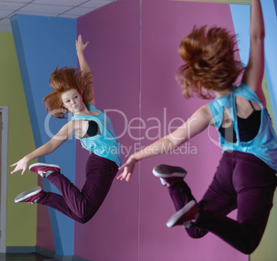 Pretty break dancer jumping up and looking in mirror