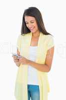 Happy casual woman sending a text