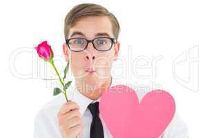 Geeky hipster holding a red rose and heart card