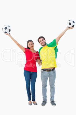 Football fan couple cheering and smiling at camera