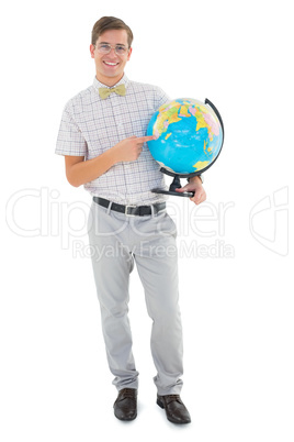 Geeky hipster holding a globe smiling at camera Geeky hipster holding a globe smiling at camera
