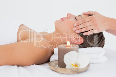 Attractive woman receiving head massage at spa center