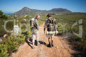 Hiking couple walking on mountain terrain