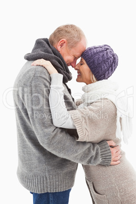 Happy mature couple in winter clothes embracing