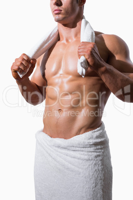 Mid section of a shirtless muscular man in white towel