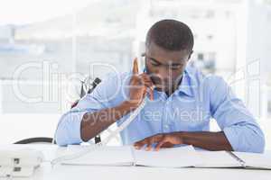 Serious businessman on the phone at desk