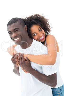 Casual couple hugging and smiling at camera