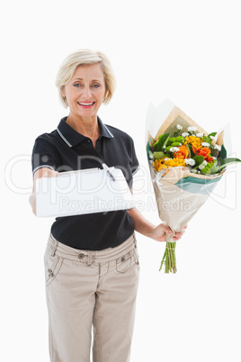 Happy flower delivery woman looking for signature