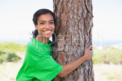 Pretty environmental activist hugging tree