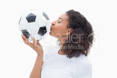 Pretty girl kissing her football