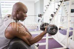 Man exercising with dumbbell in gym