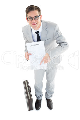 Geeky businessman showing contract to camera