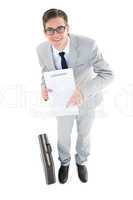 Geeky businessman showing contract to camera