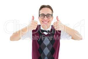 Smiling geeky hipster looking at camera showing thumbs up