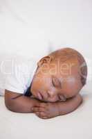 Baby boy sleeping peacefully on couch